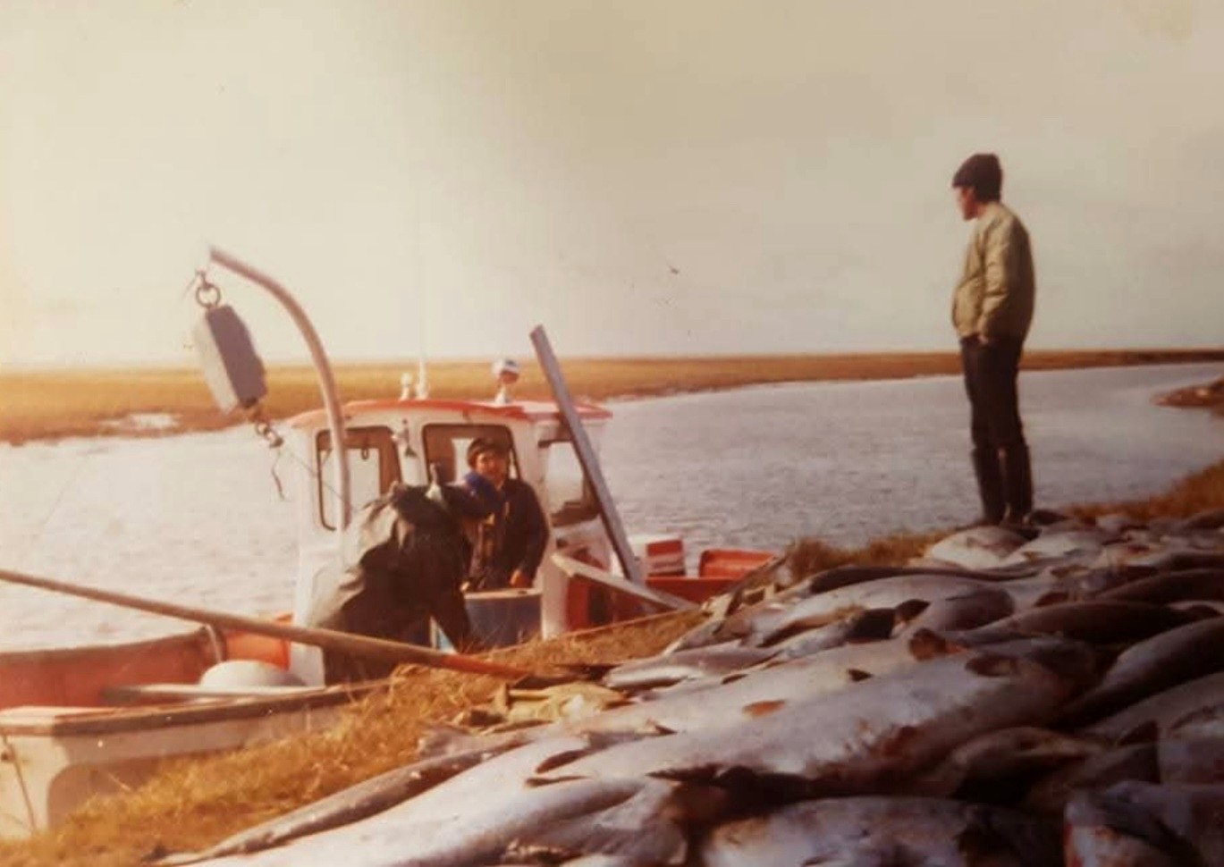 Robert Kenneth Moore and family with a salmon haul on the lower Yukon River bank near Emmonak — family archive